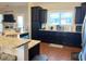 Kitchen featuring dark cabinets, granite countertops, stainless steel appliances, and natural light at 108 Kaspurr Dr, Garner, NC 27529