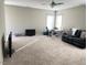 Spacious living room with carpet and a modern ceiling fan, offering a comfortable and inviting atmosphere at 108 Kaspurr Dr, Garner, NC 27529