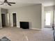 Neutral, carpeted living room with large-screen television and door for comfortable living and entertainment at 108 Kaspurr Dr, Garner, NC 27529