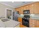 Modern kitchen with stainless steel appliances and light wood cabinets at 201 Presque Isle Ln, Chapel Hill, NC 27514