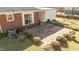 Backyard features a brick patio, mature trees, garden beds and plenty of shade at 205 N Augusta Ave, Benson, NC 27504