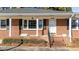 Inviting brick front porch with white columns and black shutters, showcasing the home's address above the door at 205 N Augusta Ave, Benson, NC 27504