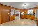 Functional kitchen area with wood cabinets and a view into the carpeted dining room at 205 N Augusta Ave, Benson, NC 27504