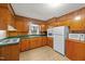 Classic kitchen with wood cabinets, a green countertop, and essential appliances at 205 N Augusta Ave, Benson, NC 27504