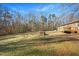 Backyard view showcasing a deck and surrounding trees at 2540 Mayo Lake Rd, Roxboro, NC 27574
