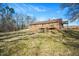 House's back view, showing a deck and expansive yard at 2540 Mayo Lake Rd, Roxboro, NC 27574