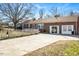 Front view of brick ranch home with driveway and picket fence at 2540 Mayo Lake Rd, Roxboro, NC 27574