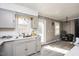 Grey kitchen cabinets, vinyl flooring, and stainless steel appliances at 2540 Mayo Lake Rd, Roxboro, NC 27574