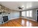 Bright living room with hardwood floors, stone fireplace, and large windows at 2540 Mayo Lake Rd, Roxboro, NC 27574