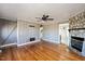 Hardwood floor living room with stone fireplace and ceiling fan at 2540 Mayo Lake Rd, Roxboro, NC 27574