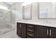 Modern bathroom with double vanity, dark wood cabinets, walk-in shower and tile flooring at 316 Church St, Morrisville, NC 27560