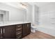 Bathroom featuring double vanities with quartz countertops and a tub/shower combo at 316 Church St, Morrisville, NC 27560