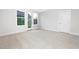 Bright bedroom with neutral carpet, a large window, and white trim at 316 Church St, Morrisville, NC 27560