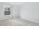 Bright bedroom featuring neutral carpet, white trim, and large windows offering great natural light at 316 Church St, Morrisville, NC 27560