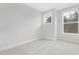 Bright bedroom featuring neutral carpet, white trim, and large windows offering great natural light at 316 Church St, Morrisville, NC 27560