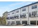Row of modern townhomes with dark-framed windows and small balconies, set against a bright sky at 316 Church St, Morrisville, NC 27560