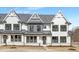 New construction townhome with modern farmhouse exterior, gray roof, and stone accents at 316 Church St, Morrisville, NC 27560