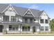 Charming modern farmhouse-style townhome featuring black window frames and a metal roof at 316 Church St, Morrisville, NC 27560