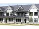 Charming modern farmhouse-style townhome featuring black window frames and a metal roof at 316 Church St, Morrisville, NC 27560