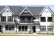 Charming modern farmhouse-style townhome featuring black window frames and a metal roof at 316 Church St, Morrisville, NC 27560