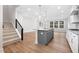 Sun-filled living room with wood floors, adjacent to the staircase and kitchen at 316 Church St, Morrisville, NC 27560