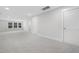 Open living space with carpet flooring, bright lighting, and multiple doorways at 316 Church St, Morrisville, NC 27560