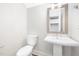 This powder room features a pedestal sink, mirror with sconces, and water closet at 316 Church St, Morrisville, NC 27560