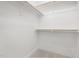 An organized walk-in closet with wooden rods for hanging clothes and neutral-colored carpeting at 316 Church St, Morrisville, NC 27560