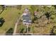 Aerial view of the home showcasing a large yard, lush landscaping, and a basketball court at 400 S Boddie St, Nashville, NC 27856