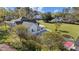 Aerial view of backyard showing the house, basketball court, and lush landscaping at 400 S Boddie St, Nashville, NC 27856