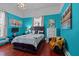 Bedroom showcasing wood flooring, modern furniture, and bright blue walls at 400 S Boddie St, Nashville, NC 27856