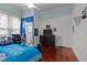 Bedroom with a dark wood bed with blue bedding, red floors, and a sports themed design at 400 S Boddie St, Nashville, NC 27856