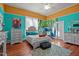 Primary bedroom features a queen-sized bed, wood floors, bright walls, and a mural at 400 S Boddie St, Nashville, NC 27856
