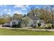 Charming white home with black shutters, complemented by a well-manicured lawn and blossoming tree at 400 S Boddie St, Nashville, NC 27856