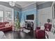 Living room with cozy red furniture, two decorated Christmas trees, fireplace, and blue accent wall at 400 S Boddie St, Nashville, NC 27856