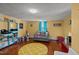 Inviting living room with yellow walls, hardwood floors, and a cozy gray loveseat at 400 S Boddie St, Nashville, NC 27856