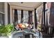 Screened porch with a porch swing, pillows, outdoor rug, and view of the surrounding yard at 400 S Boddie St, Nashville, NC 27856