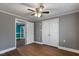 Bedroom with hardwood floors, double-door closet, and neutral walls at 408 W Main St, Pine Level, NC 27568