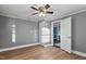 A gray bedroom featuring sleek vinyl floors, a ceiling fan, and ample natural light for a calming atmosphere at 408 W Main St, Pine Level, NC 27568