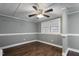 Bedroom with hardwood floors, neutral walls, and two windows at 408 W Main St, Pine Level, NC 27568