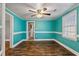 Bright dining room features hardwood floors and teal walls at 408 W Main St, Pine Level, NC 27568