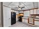 Traditional-style kitchen with white cabinets, black appliances, and stone backsplash, offering a functional space for cooking at 408 W Main St, Pine Level, NC 27568