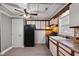 Traditional-style kitchen with white cabinets, black appliances, and stone backsplash, offering a functional space for cooking at 408 W Main St, Pine Level, NC 27568