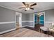 Open-concept living room with ceiling fan, chair, and trim at 408 W Main St, Pine Level, NC 27568