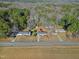 An aerial shot displays the property and its proximity to the surrounding wooded areas at 5317 Ten Ten Rd, Apex, NC 27539