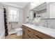 Bathroom with double vanity, marble countertops, and large mirror at 5317 Ten Ten Rd, Apex, NC 27539