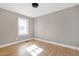 Bright bedroom with hardwood floors and large window at 5317 Ten Ten Rd, Apex, NC 27539