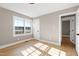 Spacious bedroom with hardwood floors and two windows at 5317 Ten Ten Rd, Apex, NC 27539
