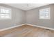 Bedroom with hardwood floors and two windows at 5317 Ten Ten Rd, Apex, NC 27539