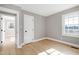 Bedroom with hardwood floors and access to another room at 5317 Ten Ten Rd, Apex, NC 27539